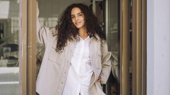 Kvinde læner sig op ad dør