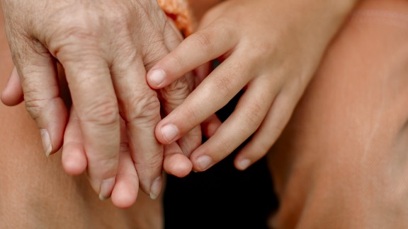 Ung og ældre holder i hånd